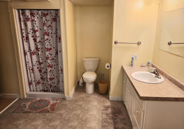 full bath featuring toilet, a shower stall, wooden walls, and vanity