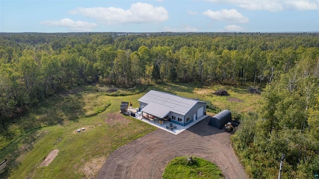 drone / aerial view with a wooded view