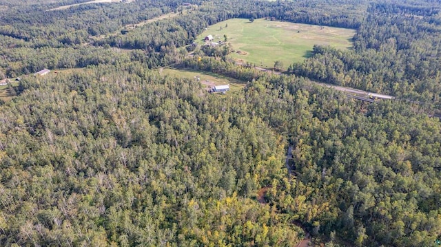 birds eye view of property featuring a view of trees