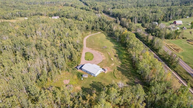 birds eye view of property with a view of trees