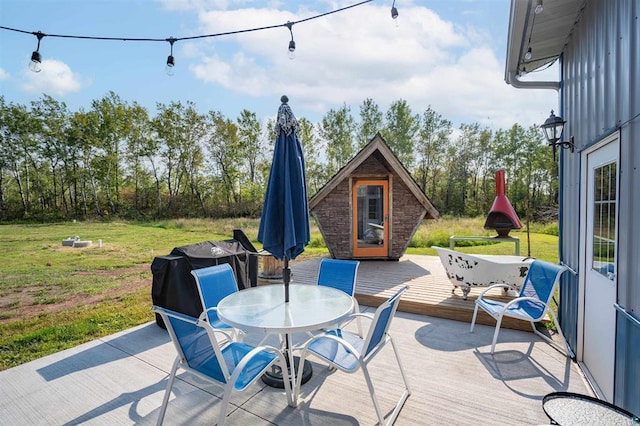 view of patio / terrace with outdoor dining area and a wooden deck