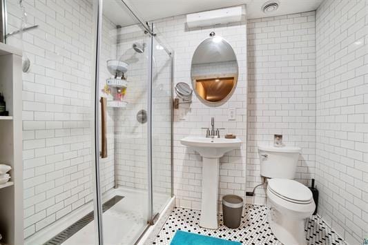 full bath featuring tile patterned flooring, toilet, tile walls, a stall shower, and a wall mounted air conditioner