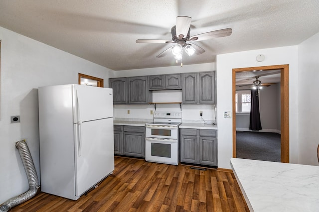 kitchen featuring white appliances, dark wood finished floors, gray cabinets, light countertops, and a textured ceiling