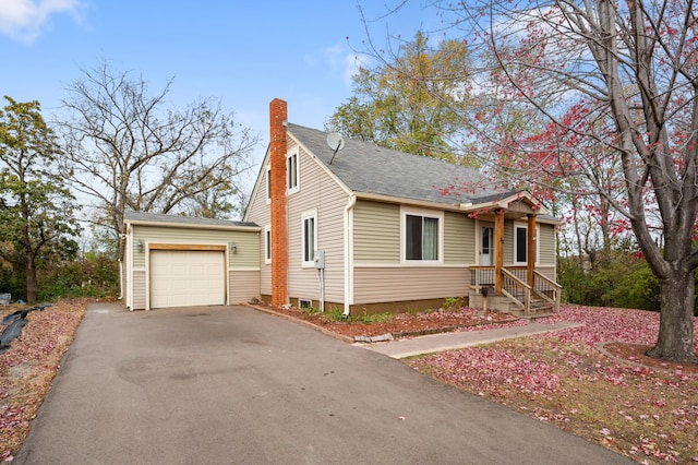 view of front of property with aphalt driveway, an attached garage, and a chimney