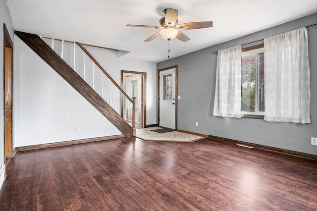 entrance foyer with baseboards, stairs, a ceiling fan, and wood finished floors