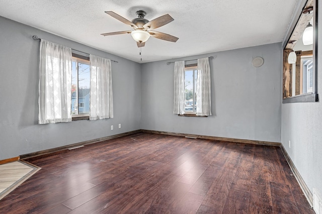 unfurnished room with baseboards, a textured ceiling, ceiling fan, and wood finished floors