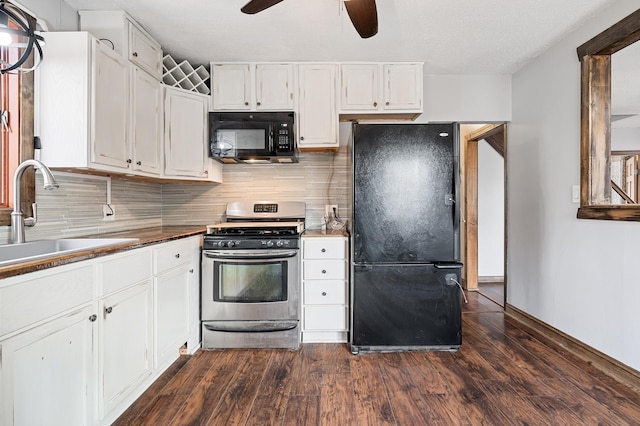 kitchen featuring black appliances, a ceiling fan, a sink, dark wood-style floors, and white cabinetry