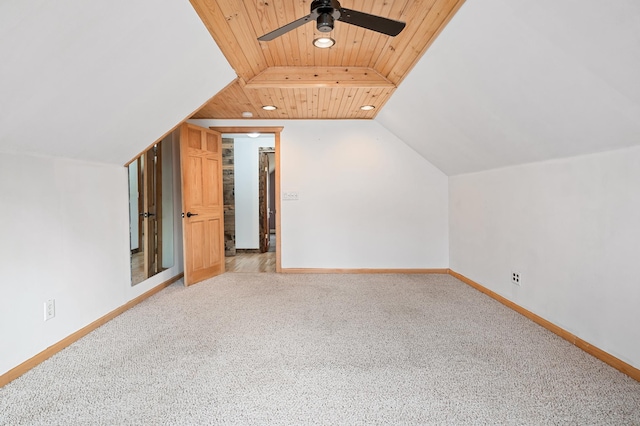 additional living space featuring baseboards, wooden ceiling, and a ceiling fan