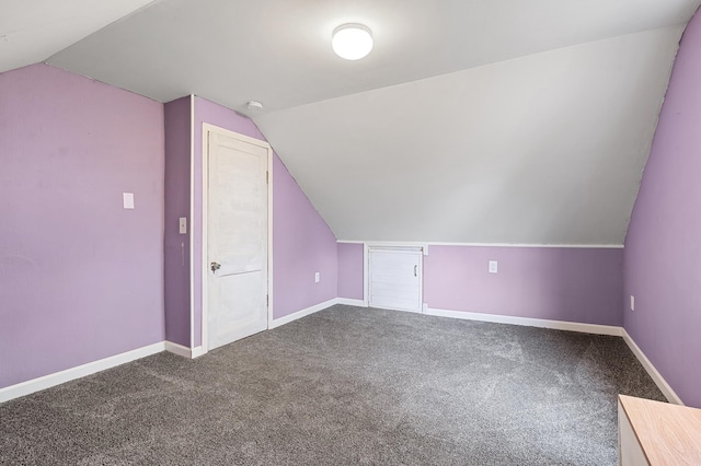 additional living space with vaulted ceiling, carpet flooring, and baseboards