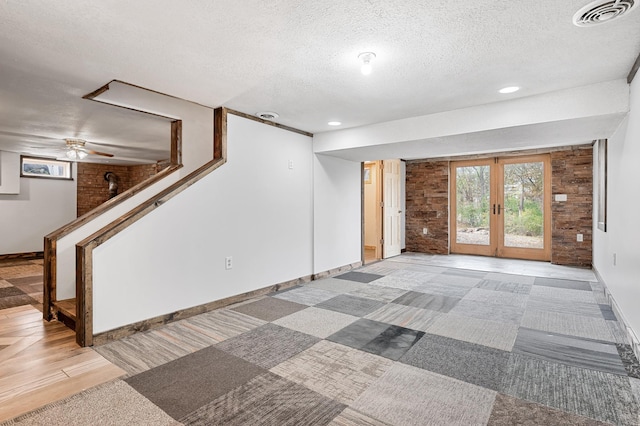 interior space featuring visible vents, a healthy amount of sunlight, french doors, and a textured ceiling