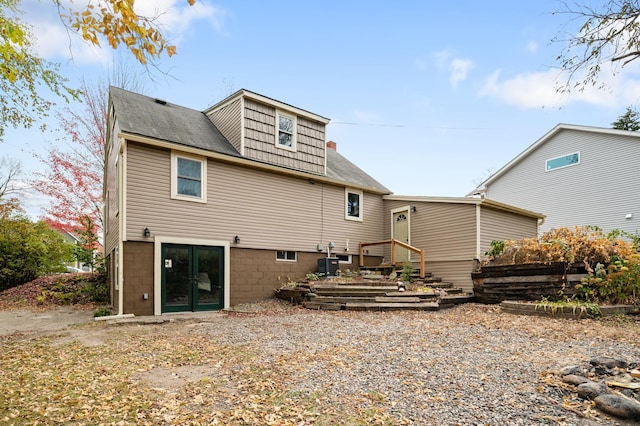 rear view of house featuring central air condition unit