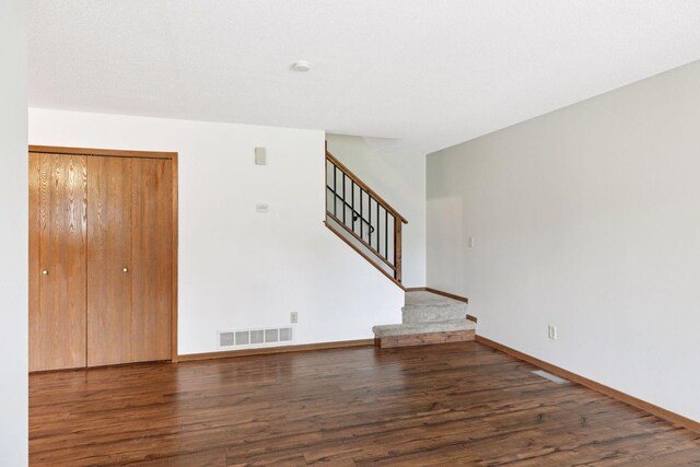 125 96th Ln NE, Blaine, MN 55434 - unfurnished living room featuring wood finished floors, stairway, and baseboards