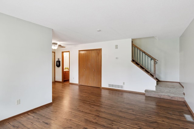 125 96th Ln NE, Blaine, MN 55434 - unfurnished living room with wood finished floors, stairway, baseboards, and ceiling fan