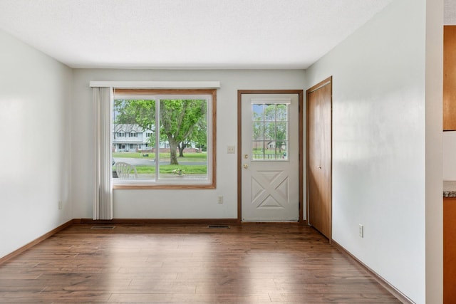 125 96th Ln NE, Blaine, MN 55434 - doorway to outside with wood finished floors and baseboards