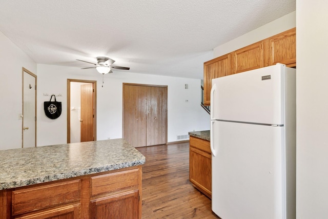 125 96th Ln NE, Blaine, MN 55434 - kitchen featuring freestanding refrigerator, a ceiling fan, light wood finished floors, and brown cabinetry