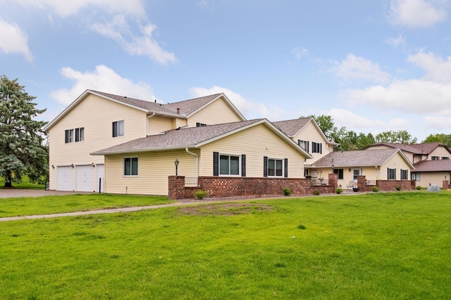 125 96th Ln NE, Blaine, MN 55434 - traditional-style house featuring an attached garage, brick siding, a front lawn, and driveway