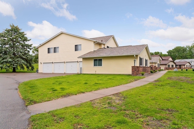 125 96th Ln NE, Blaine, MN 55434 - view of side of property with an attached garage, driveway, and a lawn