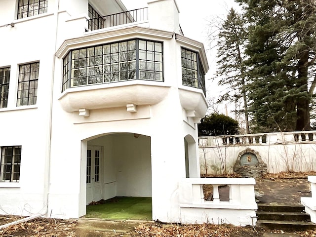 exterior space featuring a balcony and stucco siding