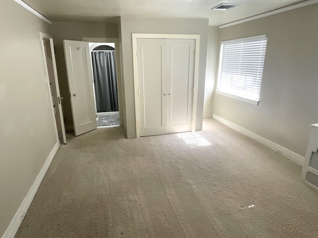 401 5th Ave SW, Austin, MN 55912 - unfurnished bedroom featuring baseboards, carpet flooring, and visible vents