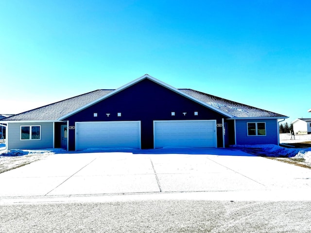 ranch-style house featuring driveway and an attached garage