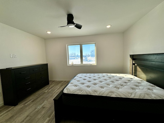 bedroom featuring ceiling fan, recessed lighting, wood finished floors, and baseboards