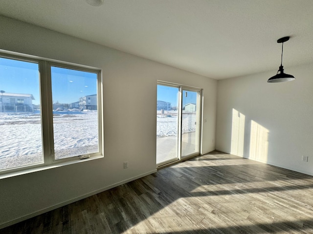 spare room with wood finished floors and baseboards