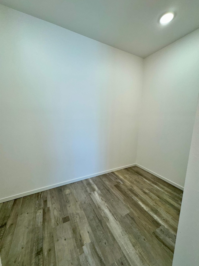 unfurnished room featuring baseboards and wood finished floors