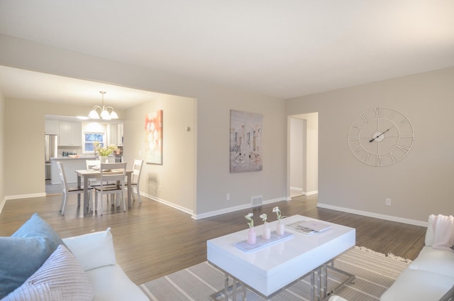 living area with baseboards, visible vents, and dark wood finished floors