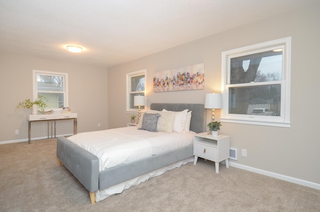 bedroom featuring carpet floors, visible vents, and baseboards