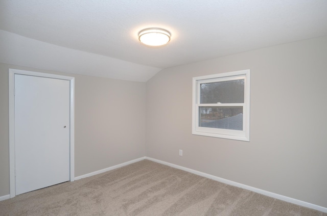 bonus room featuring carpet floors, baseboards, and vaulted ceiling