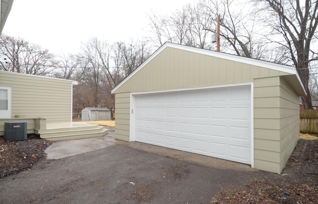 detached garage with cooling unit and fence