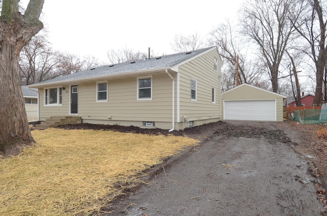 view of front of home with a garage, entry steps, and an outdoor structure