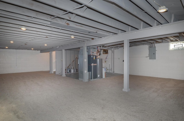 basement with water heater, carpet, and electric panel