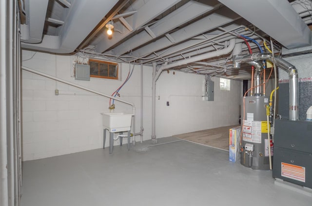 basement featuring electric panel and water heater