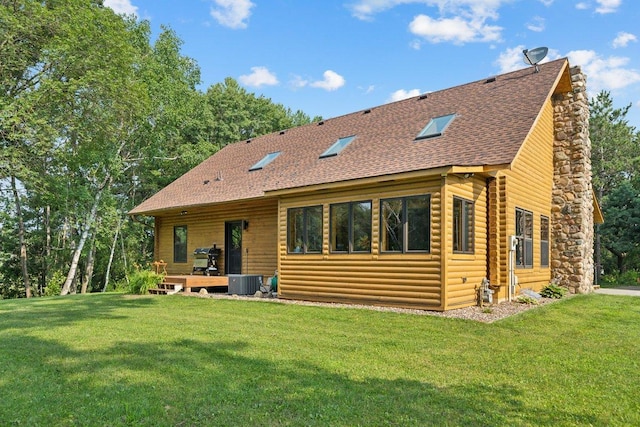 11669 Dellwood Rd, Grant, MN 55082 - back of property with a shingled roof, a yard, central air condition unit, and log veneer siding