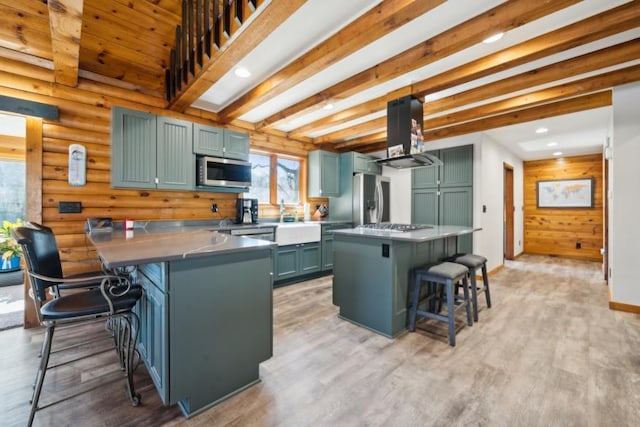 11669 Dellwood Rd, Grant, MN 55082 - kitchen featuring appliances with stainless steel finishes, a breakfast bar area, green cabinets, extractor fan, and light wood-type flooring