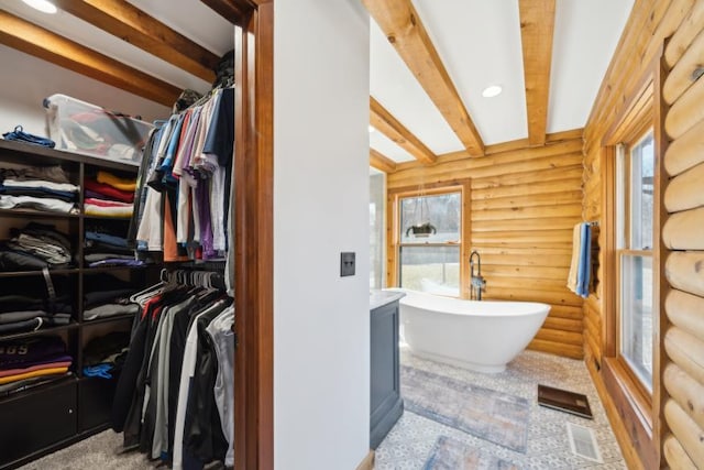 11669 Dellwood Rd, Grant, MN 55082 - bathroom with log walls, a soaking tub, a walk in closet, and beam ceiling