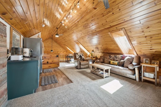 11669 Dellwood Rd, Grant, MN 55082 - living room featuring ceiling fan, wooden walls, carpet floors, rail lighting, and vaulted ceiling