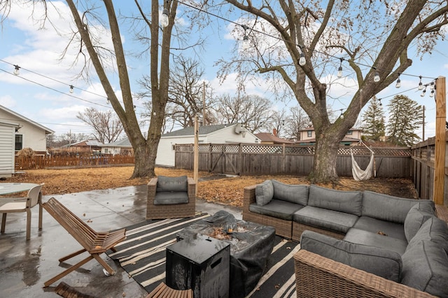 view of patio with a fenced backyard and an outdoor living space with a fire pit