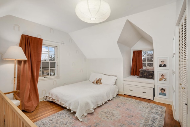 bedroom featuring vaulted ceiling and wood finished floors