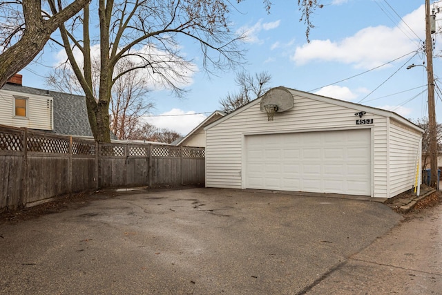 detached garage featuring fence