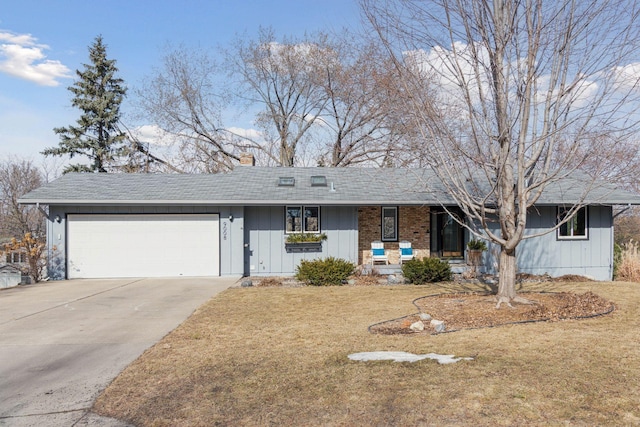 ranch-style house featuring a front yard, a porch, a shingled roof, concrete driveway, and a garage