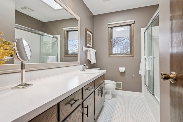 bathroom featuring tile patterned floors, visible vents, toilet, and vanity