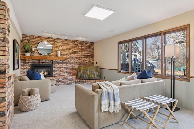 carpeted living area featuring visible vents and a brick fireplace