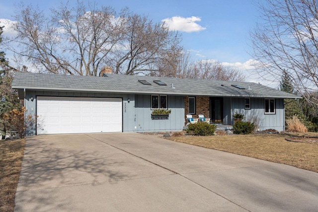 single story home featuring a front lawn, a porch, concrete driveway, an attached garage, and a chimney