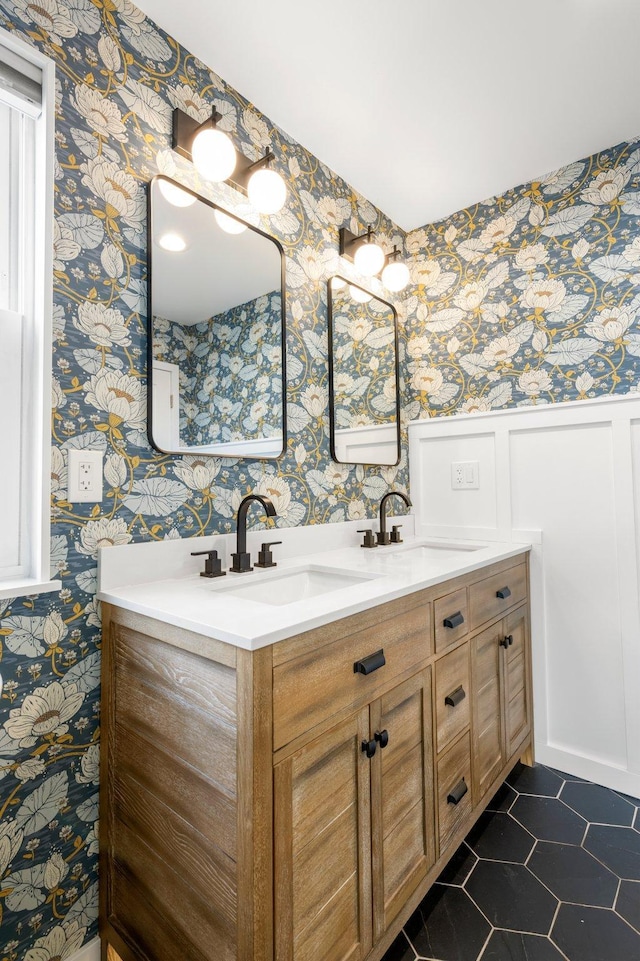 bathroom featuring wallpapered walls, tile patterned floors, and a sink