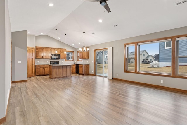 kitchen with visible vents, brown cabinetry, open floor plan, light countertops, and black appliances