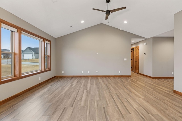 unfurnished room with light wood-style flooring, baseboards, vaulted ceiling, and a ceiling fan