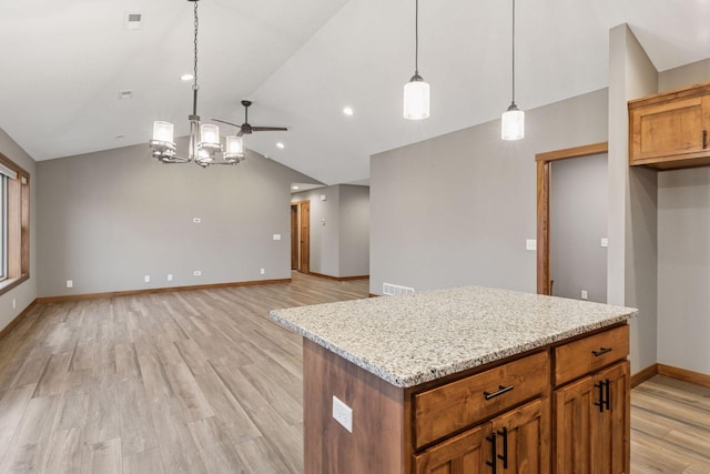 kitchen with lofted ceiling, light wood-style flooring, brown cabinetry, and hanging light fixtures