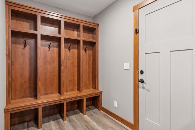 mudroom with light wood finished floors and baseboards